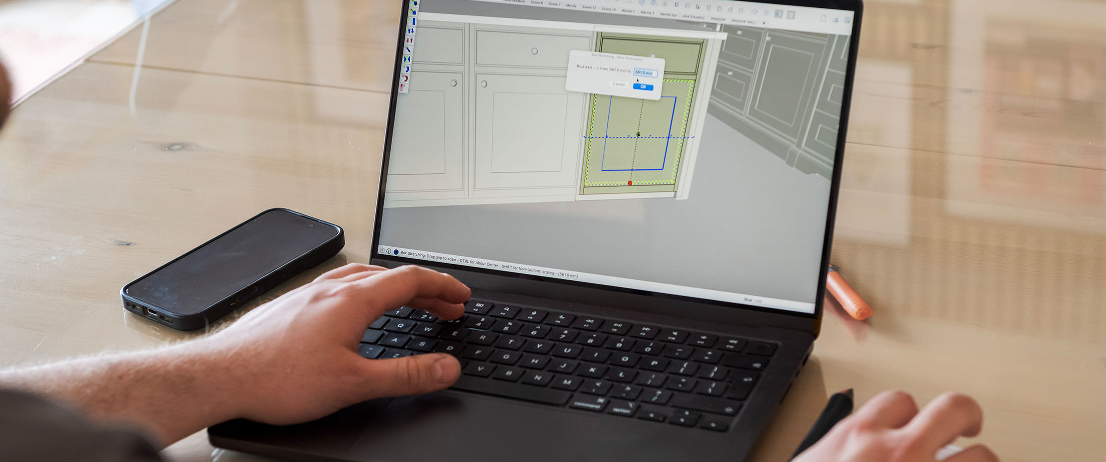 Person on laptop designing a kitchen